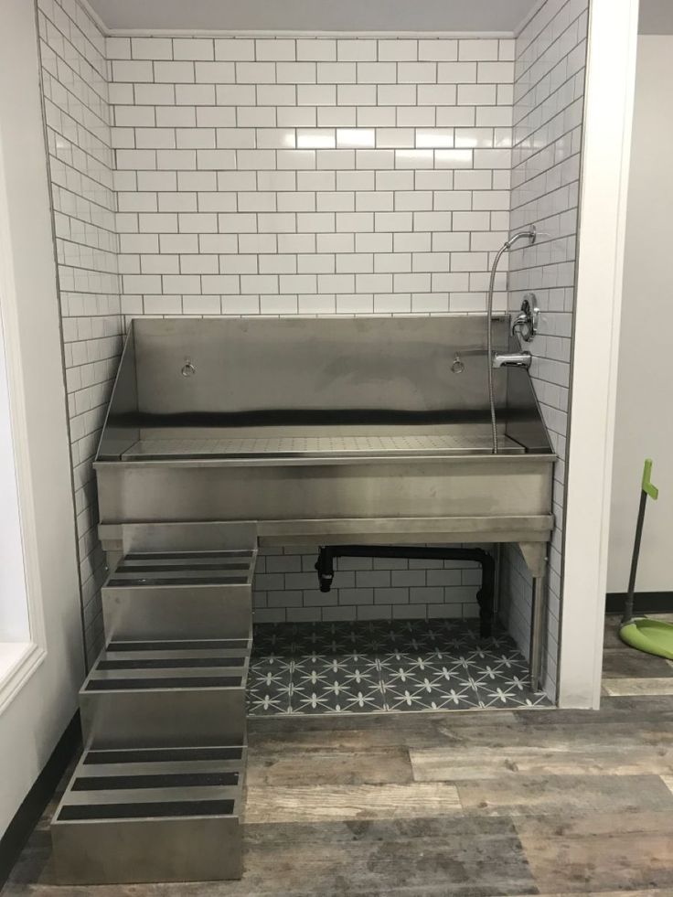 an industrial kitchen with stainless steel steps leading up to the sink