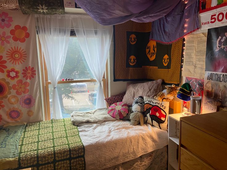 a bed room with a neatly made bed next to a window