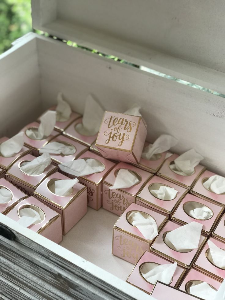 pink and white boxes with tissue paper in them