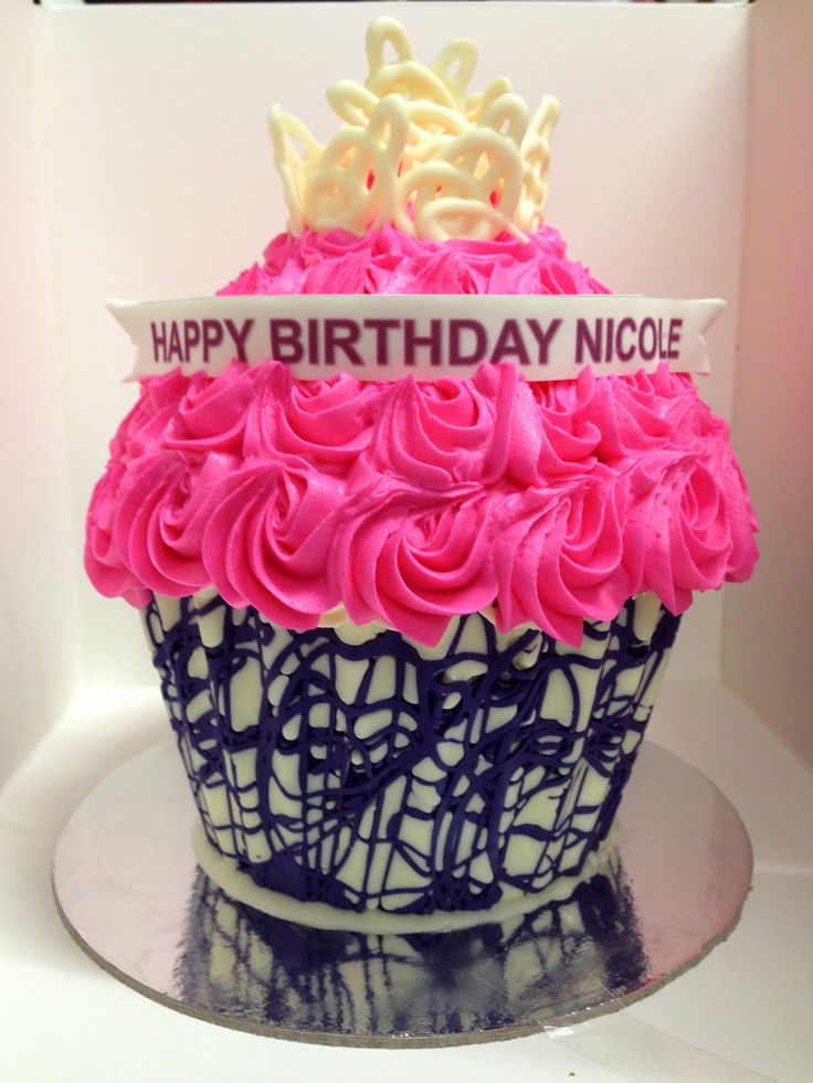 a birthday cupcake with pink frosting and a crown on top that says happy birthday nicole