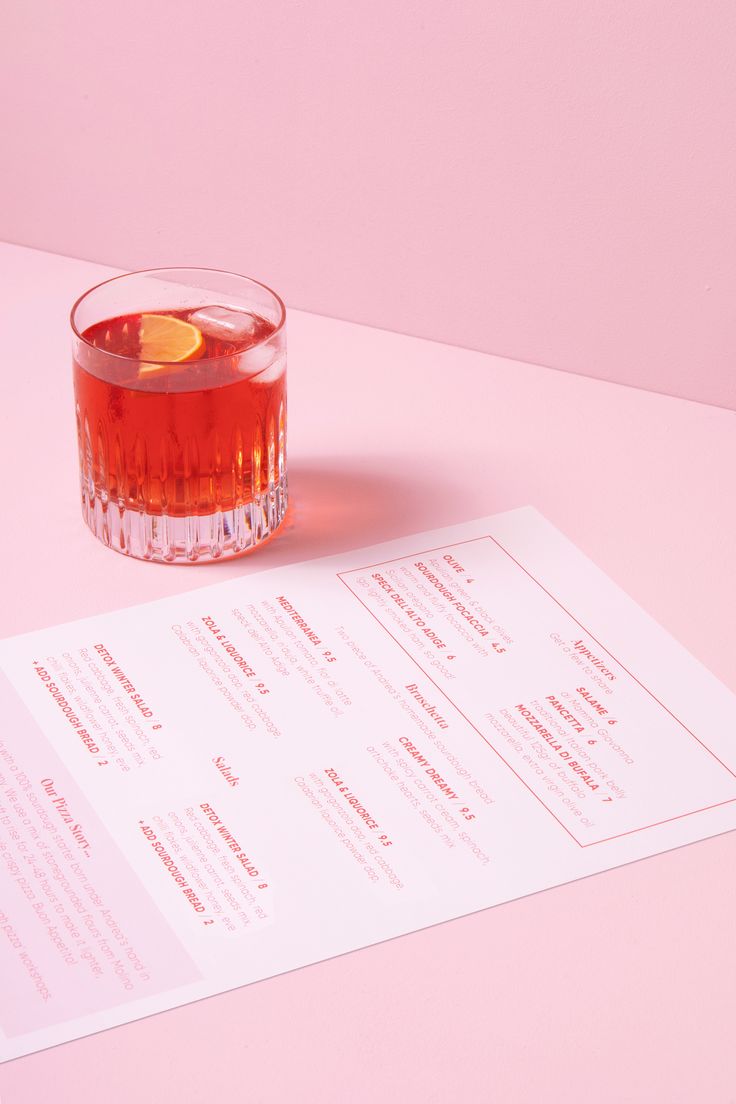 a drink sitting on top of a table next to a menu