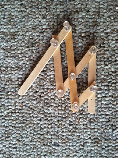 two wooden pegs sitting on top of a carpet