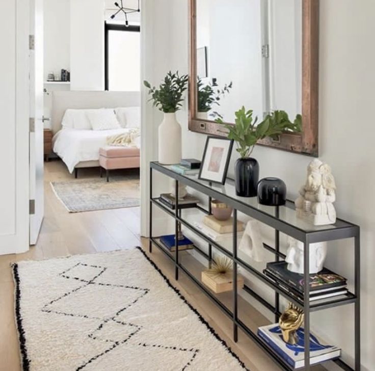 a living room with a mirror and some plants