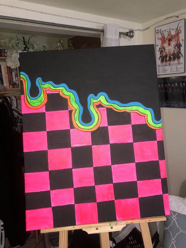 a black and pink checkered painting on easel