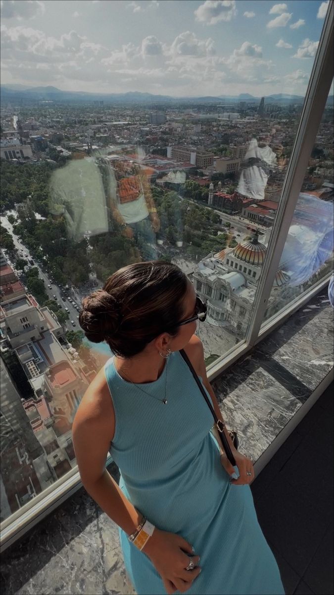 a woman standing on top of a tall building