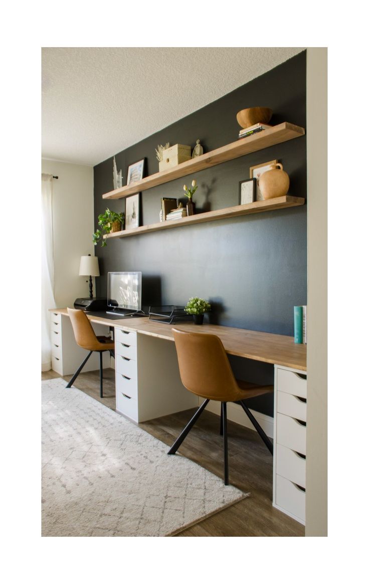 an office with two desks and shelves on the wall