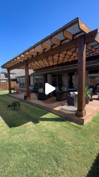 an outdoor living area with patio and pergolated roof