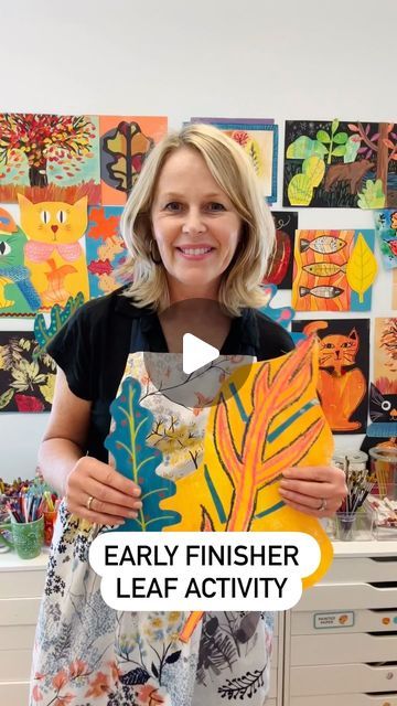 a woman holding up a piece of art with the words, early finisher leaf activity