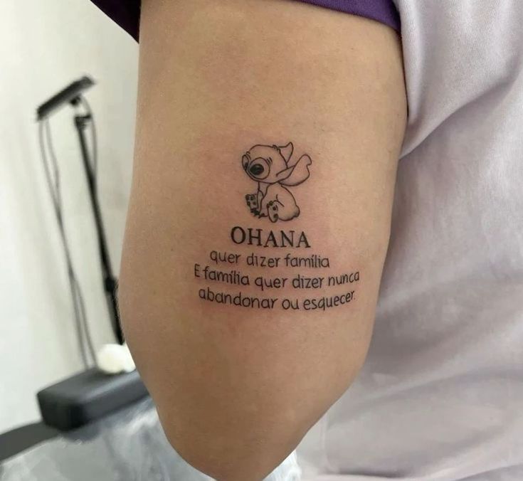 a woman with a tattoo on her arm that says ohana and an image of a koala bear