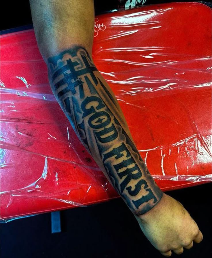 a man's arm with the words life is good here tattooed on his left forearm