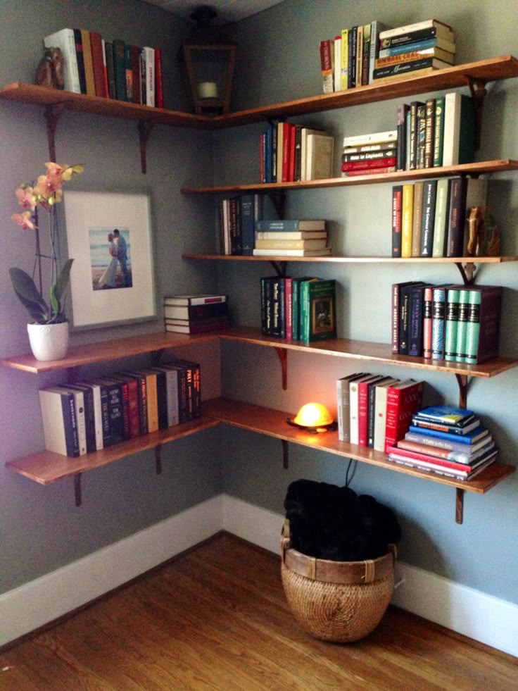 a room that has some books on the shelves and a basket in front of it