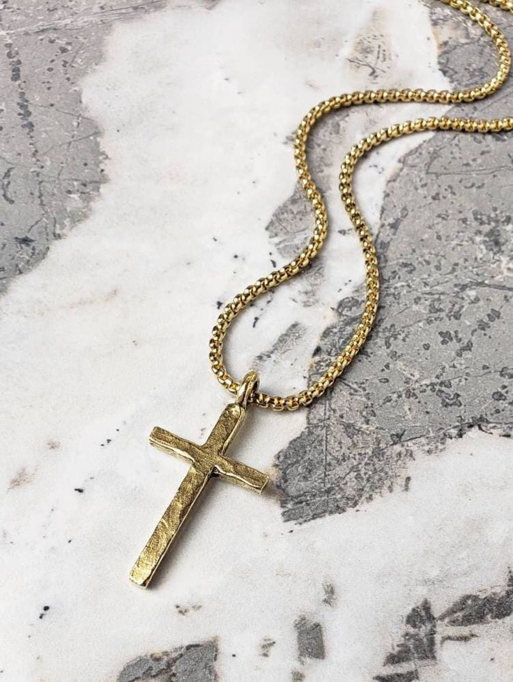 "《《  PENDANT COLLECTION  》》 THE DETAILS The \"RUSTIC GOLD CROSS\" Necklace is designed with an exquisitely detailed Hammered Gold Stainless Steel Cross Pendant, with a cool rustic vibe, hung from a Gold Stainless Steel Box Chain available in your choice of length! 💠🔷️💠View the entire PENDANT COLLECTION here: https://www.etsy.com/shop/MrMacKJewelry?ref=ss_profileFref§ion_id=30638859 MATERIALS * 1 1/4\" × 1/2\" Hammered Gold Stainless Steel Rustic Cross Pendant  * 3mm Gold Stainless Steel Box C Gold Adjustable Chain Jewelry For Father's Day, Father's Day Gold Jewelry With Adjustable Chain, Classic Gold Necklaces For Father's Day, Mens Cross Pendant, Minimalist Gold Jewelry For Father's Day, Gold Cross Necklace For Father's Day, Gold Cross Necklace Men, Cross Pendant Necklace Men, Stainless Steel Cross Pendant