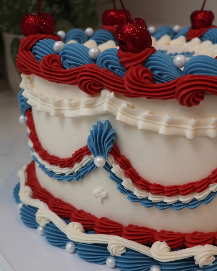 a red, white and blue cake with cherries on top