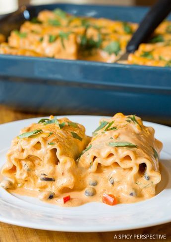 two ravioli stuffed with cheese and vegetables on a white plate