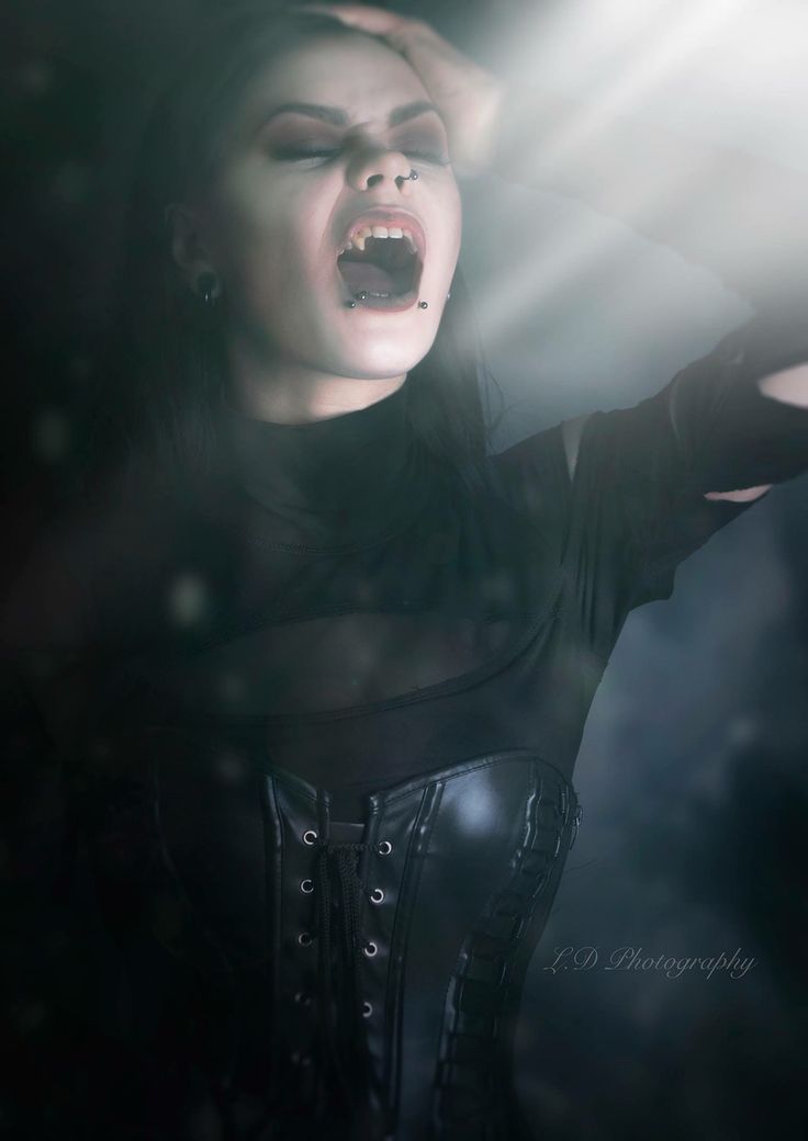 a woman with her mouth open in the dark