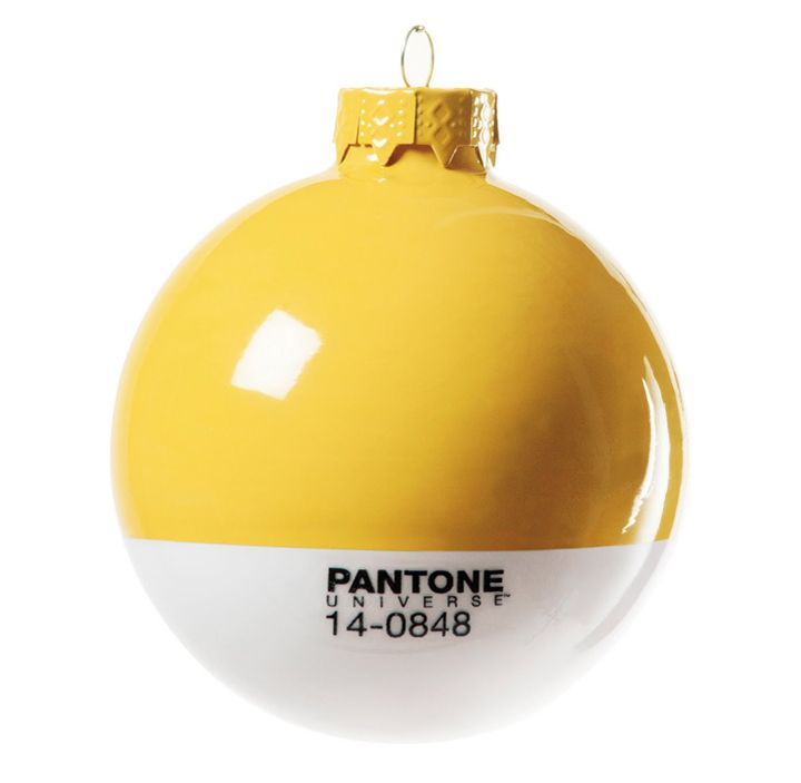 an ornament with two different colors on the front and one is yellow, white, blue, and red