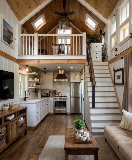 a living room filled with furniture and a staircase