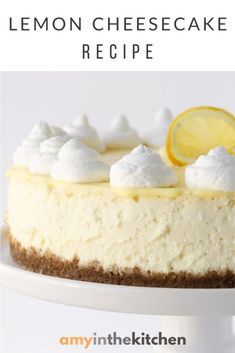 a lemon cheesecake on a white cake plate with the words, lemon cheesecake