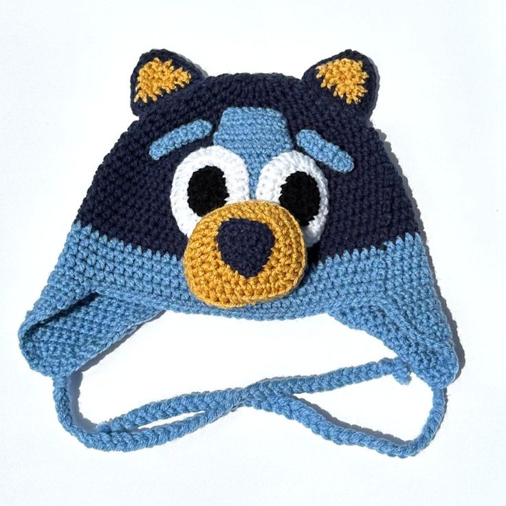 a crocheted hat with a bear face on it