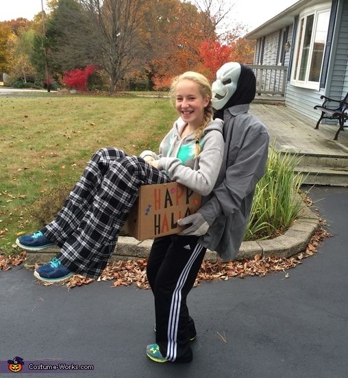 two people in costumes sitting on a bench with a sign that says i am happy