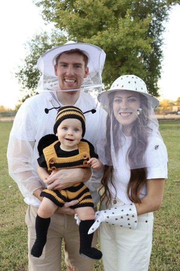 a man and woman are dressed up as bees for their halloween costume contest, while the baby is wearing a bee costume