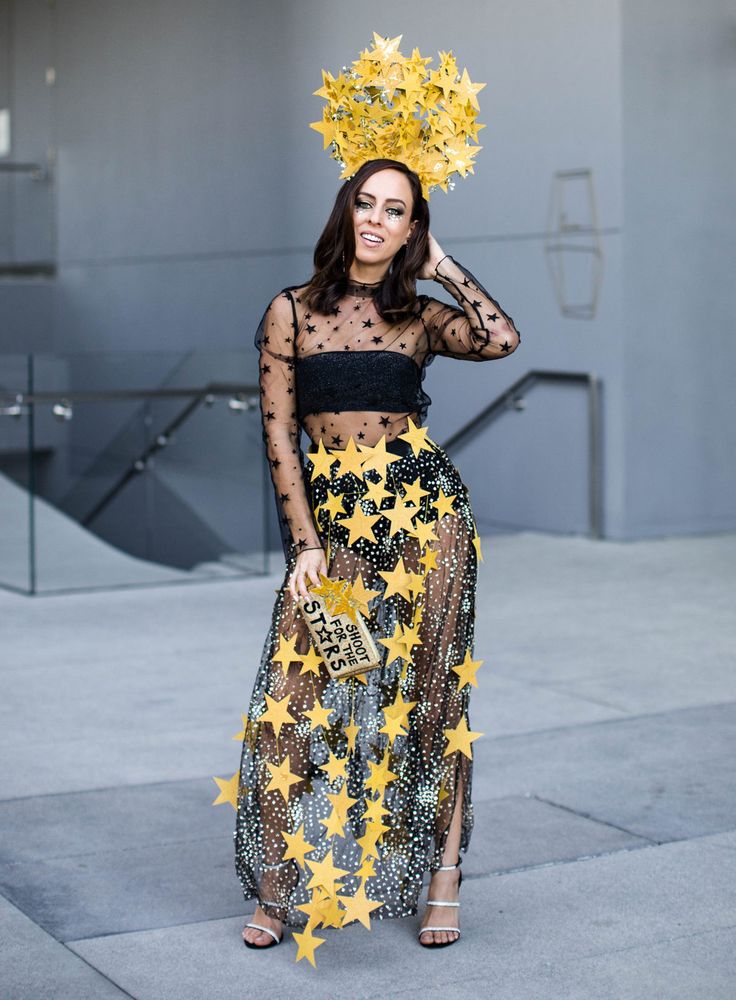 a woman in a black top and yellow star skirt