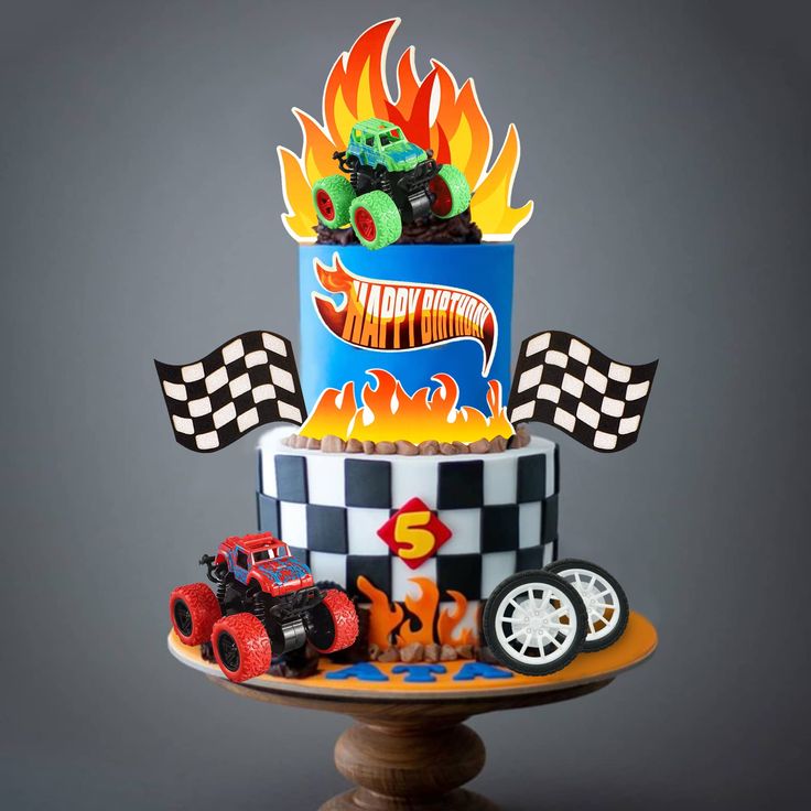 a three tier cake decorated with cars and flames