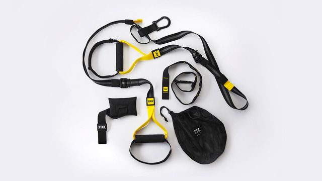 an assortment of exercise equipment laid out on a white surface