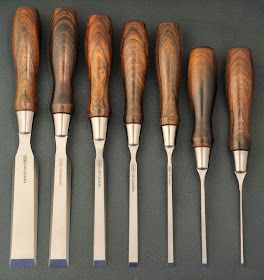 seven wood carving tools lined up in a row