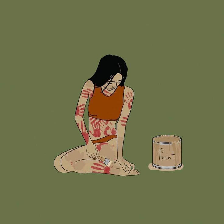 a woman sitting on the ground next to a can of peanut butter with her hands painted