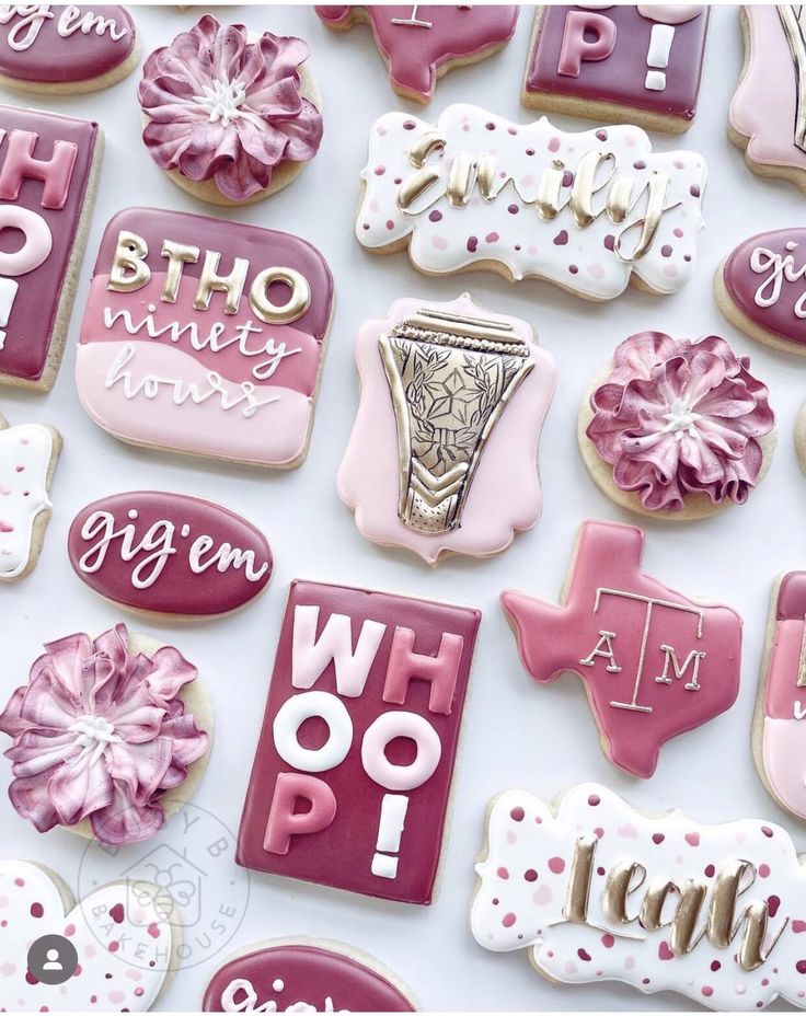 many decorated cookies are arranged on a table top with pink and white icing, which reads who do i am?