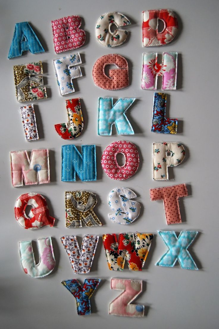 the letters are made out of fabric and have different designs on them, including one for each letter