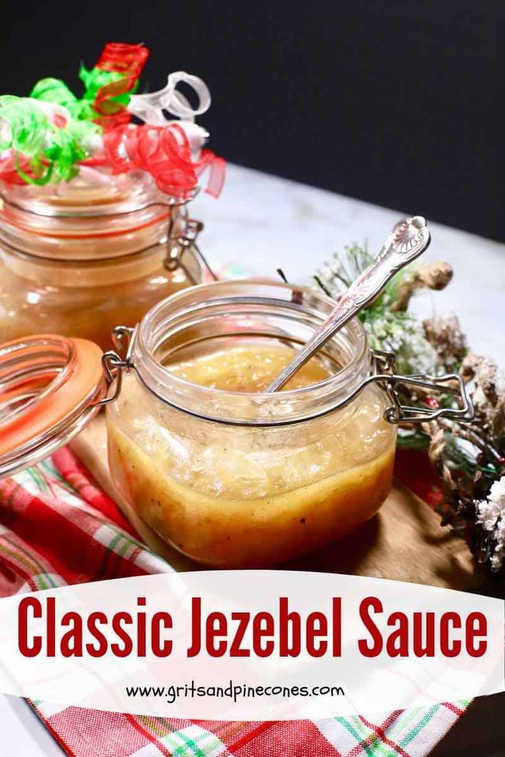 two jars filled with liquid sitting on top of a wooden cutting board next to christmas decorations