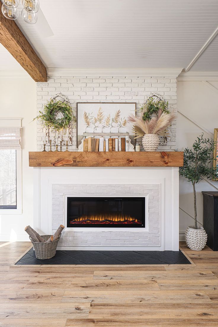 a fireplace with white brick and wood mantle