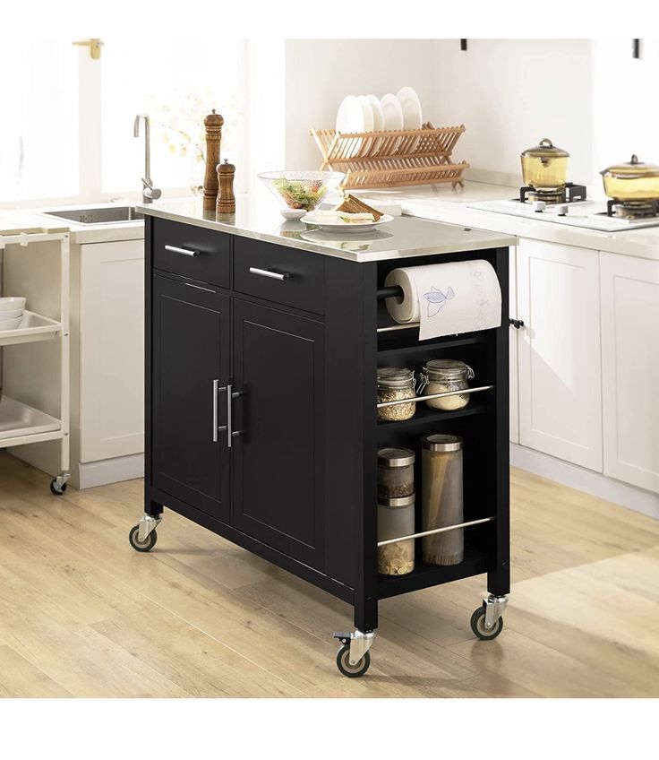 a kitchen island cart with lots of items on it