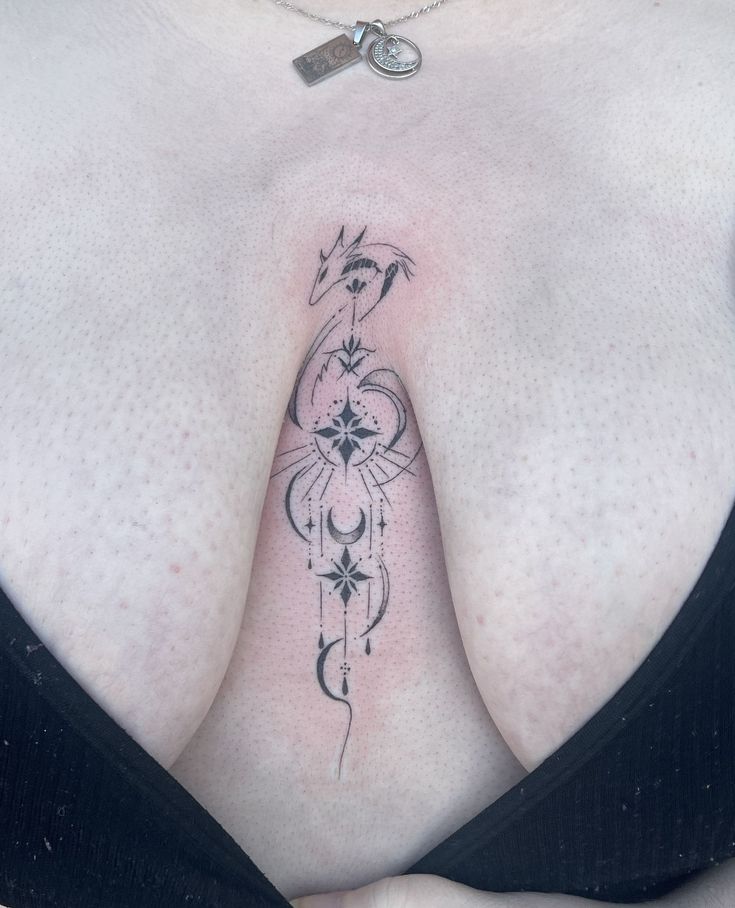 a woman's breast with an intricate tattoo on her left side, and the bottom part of her chest