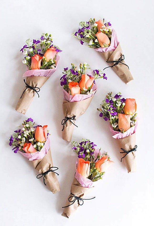 flowers are wrapped in brown paper and tied with black string on the left side of the page