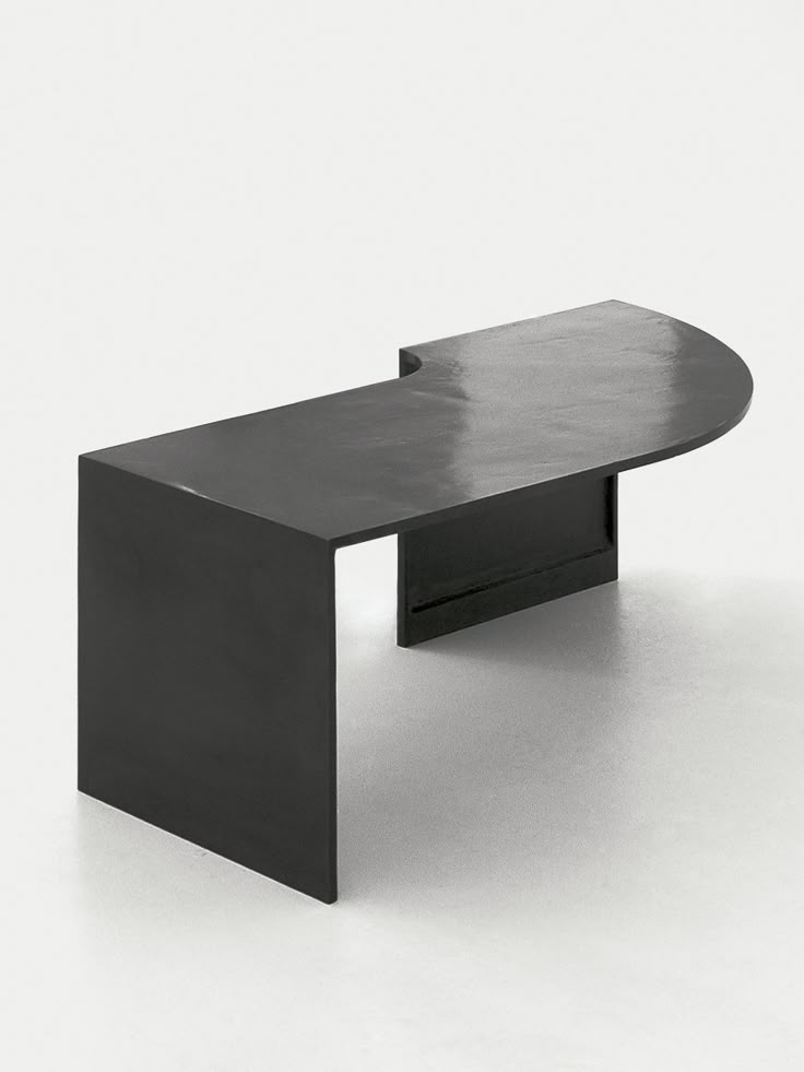 a black table sitting on top of a white floor