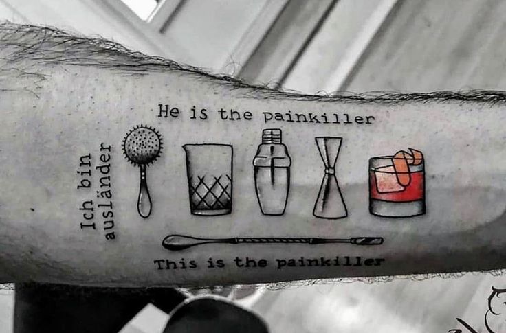 a man's arm with some tattoos on it and the words he is the painkill