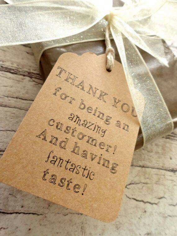 a gift wrapped in brown paper with a white ribbon and tag that says, thank you for being an amazing customer and having fantastic taste