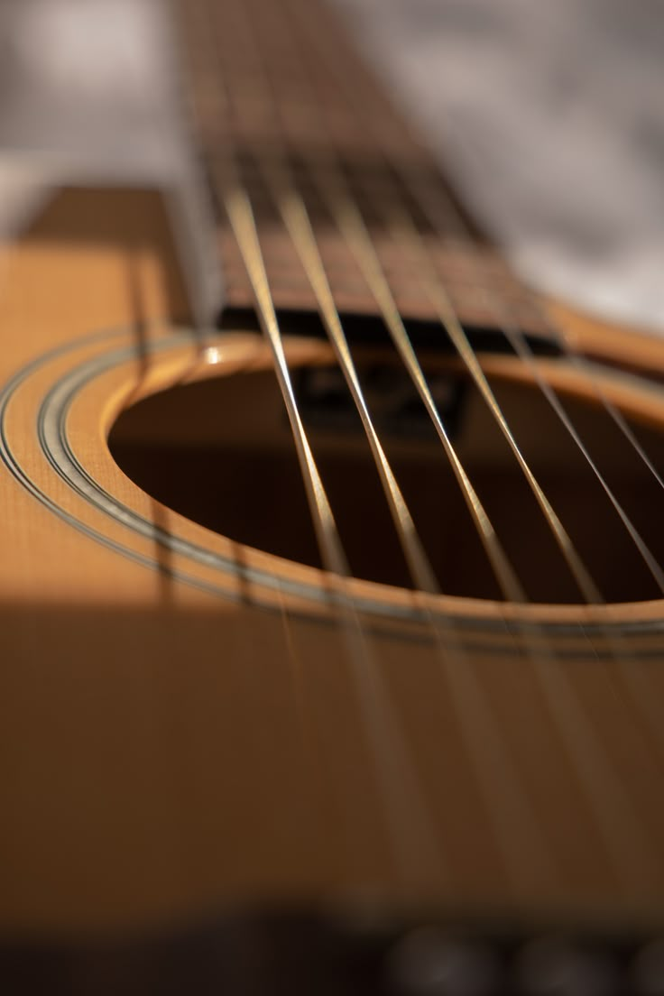 an acoustic guitar is shown in close up