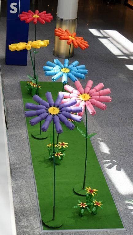 some fake flowers that are in the grass