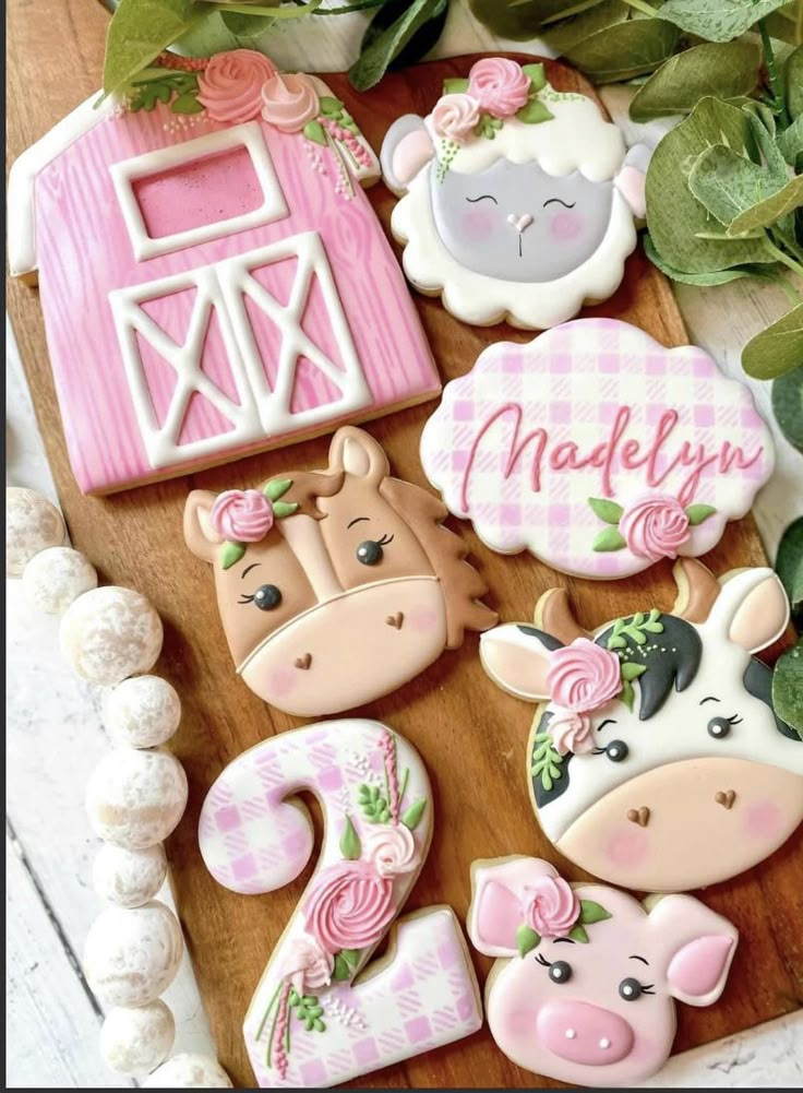 decorated cookies on a cutting board with flowers