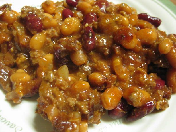 a white plate topped with meat and beans