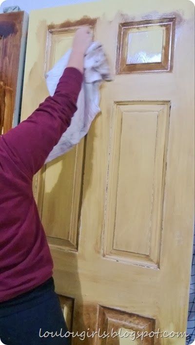 a woman painting the front door of a house