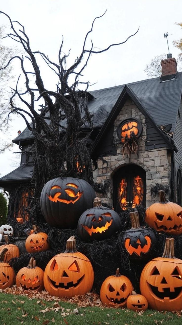 pumpkins are stacked up in front of a house decorated for the halloween season with jack - o'- lanterns