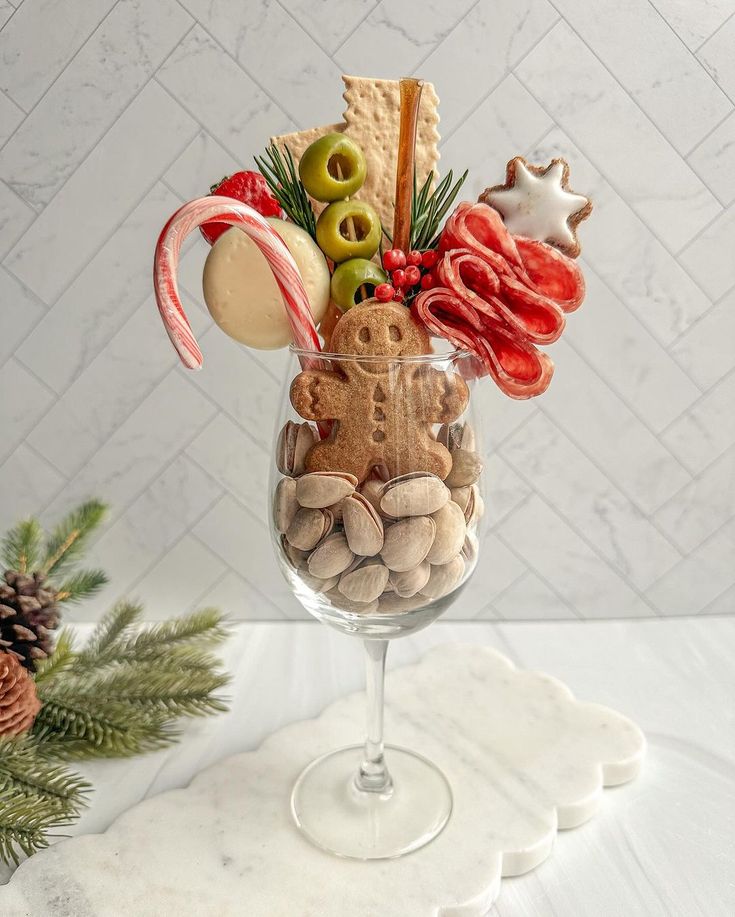 a wine glass filled with food and candy