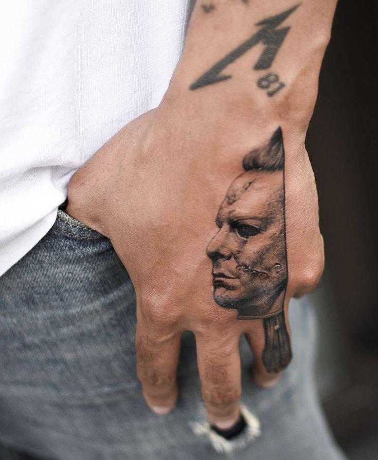 a man's hand with a tattoo on it