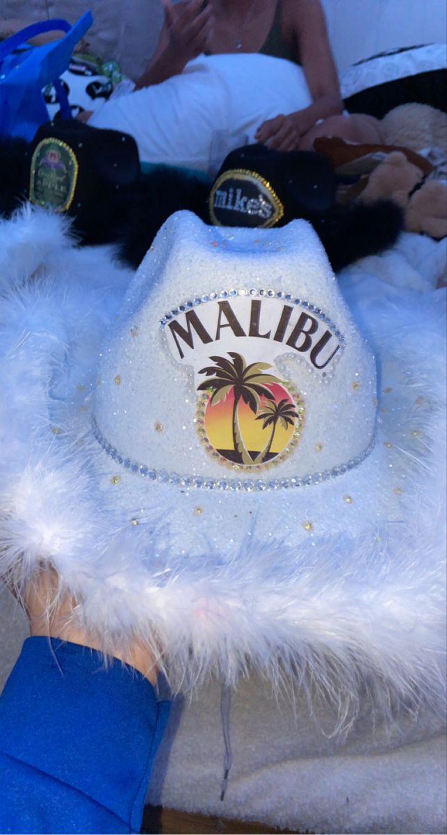 a person wearing a white hat with palm trees on it