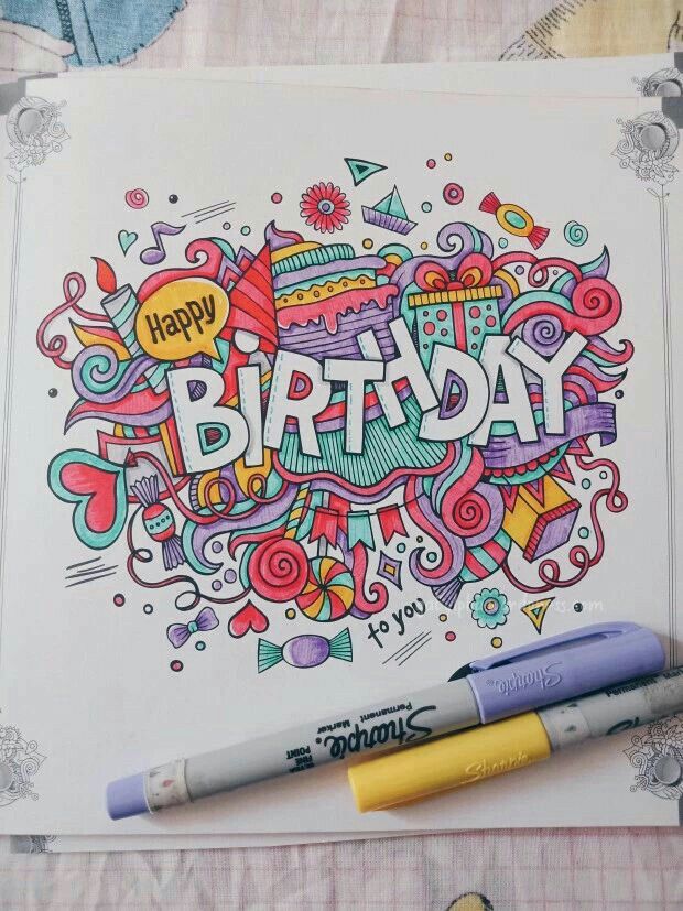 a happy birthday greeting card with markers and crayons on the table next to it